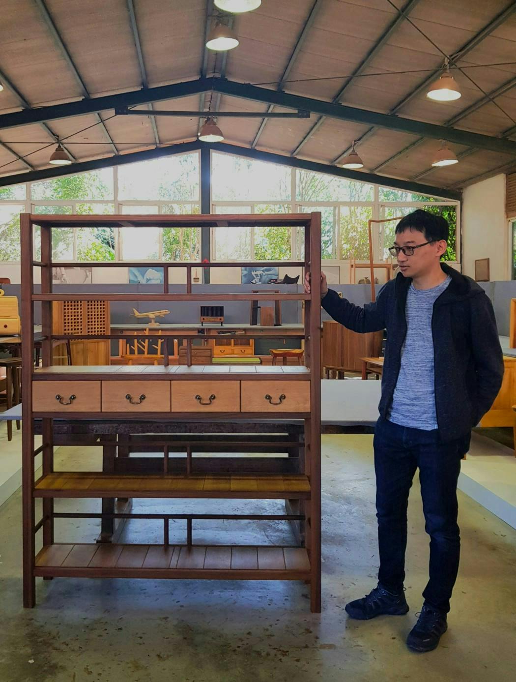 Zhou and his handmade bookshelf. Zhou is a woodworking hobbyist and software developer.