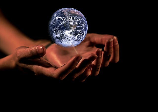 The earth hovering over a hand — splash.com